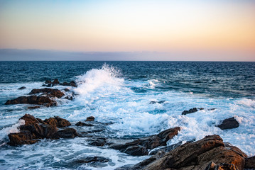 evening sky over the ocean and blue waves