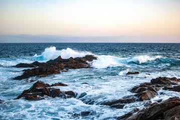 evening sky over the ocean and blue waves