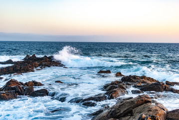 evening sky over the ocean and blue waves