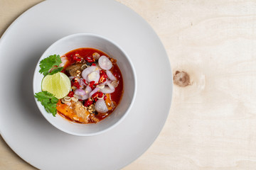 Salad of sardines in tomato sauce in a white cup to mark the image.