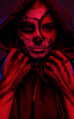 Female skeleton adjusting hood under red light