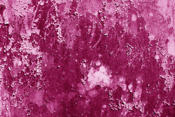 Grungy rusted metal wall surface in pink tone.