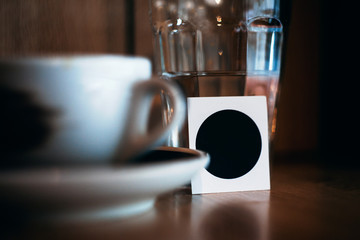 Cup of coffee and glass in a cafe blur tinting