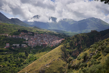 Landscape Picture of beautiful small historical town or village Isnello located in Madonie mountain range in Italy in Palermo Province of island Sicily. Picture is taken in partly cloudy spring day.