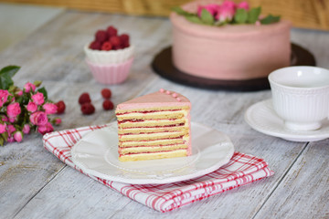 Slice of layered creamy fruit cake. Raspberry layer cake.