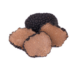 Black truffles isolated on a white background. Fresh sliced truffle. Delicacy exclusive truffle...