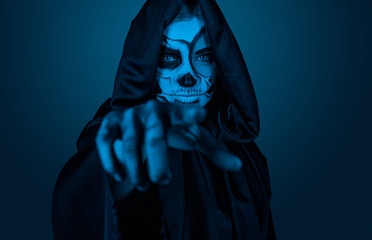 Female in Halloween costume pointing at camera