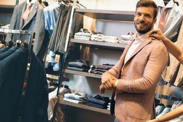 Customer man in man’s cloths store having help