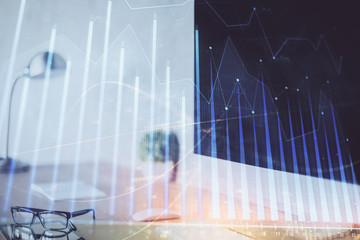 Forex graph hologram on table with computer background. Multi exposure. Concept of financial markets.