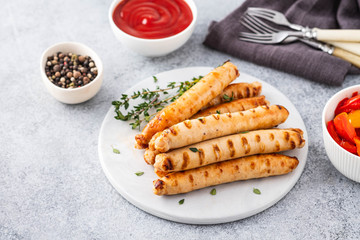 Grilled sausages on light background. Copy space.
