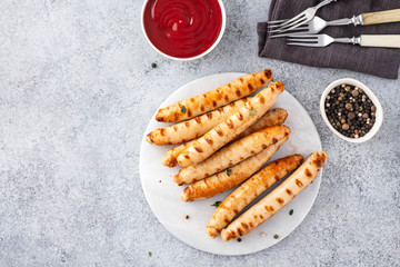 Grilled sausages on light background. Copy space.