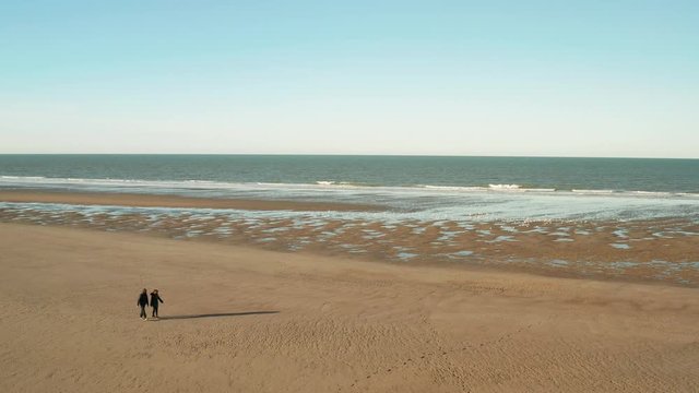 Dunkirk beach, two people and seagulls (Dunkerque, France)