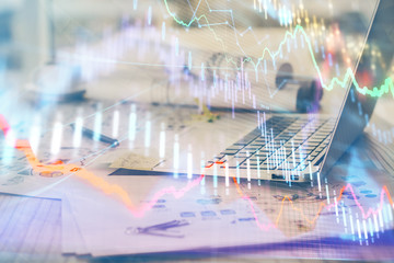 Naklejka premium Stock market graph and table with computer background. Double exposure. Concept of financial analysis.