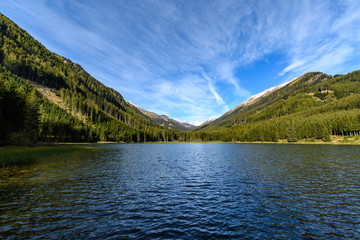 Lake "Ingeringsee" surrounded by snowcapped Seckau Alps in Styria, Austria