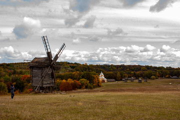 Plakat Wooden mill. Cloudy autumn day in a countryside mill village. Autumn rural landscape
