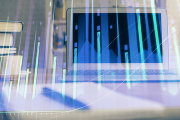 Forex market graph hologram and personal computer on background. Double exposure. Concept of investment.