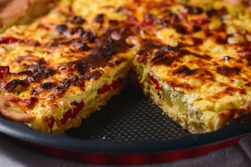 cheese quiche with broccoli, cauliflower, carrots and tomatoes. Vegetable Colorful Pie. Homemade quiche with chicken, goat cheese and spinach. Selective focus