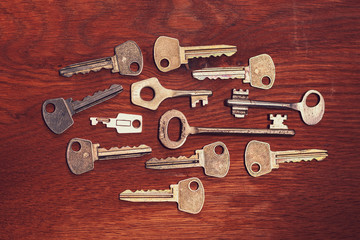 several keys laid out on a wooden surface