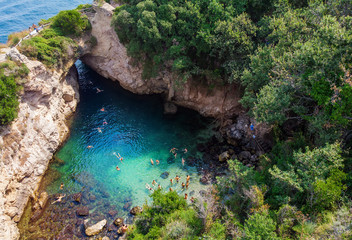 People bathing in Sorrento at Regina Giovanna Queen's bath - Tourists swimming in crystal clear...