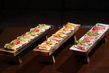 Dumplings with potato in sour cream on a wooden board.  Dumplings with mushrooms. Dumplings with cherries.