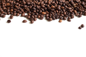 Freshly roasted coffee beans laid out on a white surface from top to bottom with a copy-paste place below.