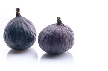 Ripe figs on a white background. Delicious tropical fruits. Horizontal shot. Copy space