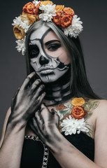 Female zombie in wreath touching hair