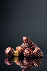 Chocolate candies on a black background.