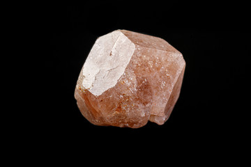 macro mineral garnet stone on a black background