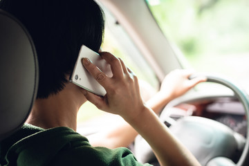 woman talking on cellphone when driving