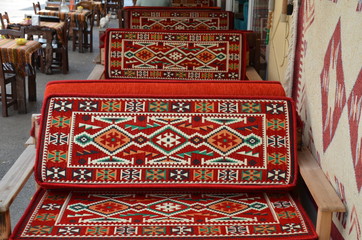 traditional turkish carpet on a sofa in a restaurant. outside