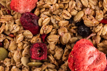 Muesli oat cereals close up background with dry fruits