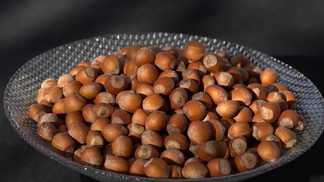 Ripe Wild Hazelnuts rotation in bowl - (4K)