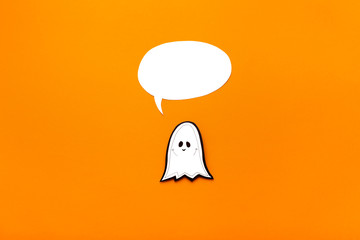 Baby ghost with speech bubble on orange background