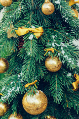 Green fir tree with golden balls. Christmas wallpaper.