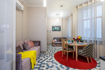 Modern interior of light studio apartment. Living room.