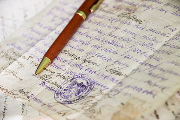 pen lies on manuscript from old paper