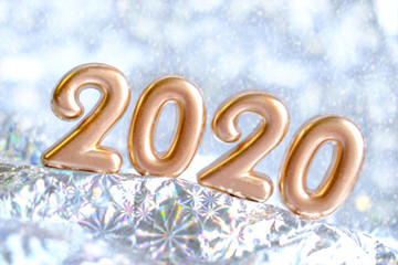 2020 golden Merry christmas and Happy New Year design banner. Blurred silver snow background. Greeting card with lettering gold 2020. Selective focus