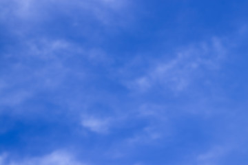 Abstract blurred background Blue sky with white clouds in sunlight.