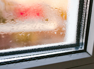 Moist on wet window. Window glass with high air humidity. Background of natural water condensation....