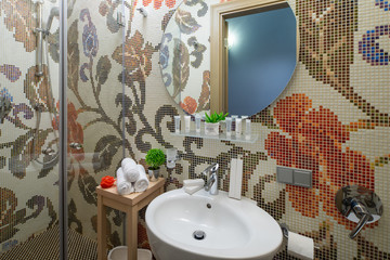 Modern interior of bathroom. Shower. Tiled patterns.