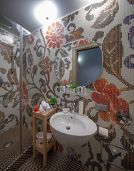 Modern interior of bathroom. Shower. Tiled patterns.