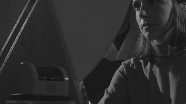 Scientist hypnotizing a woman in a scientific lab