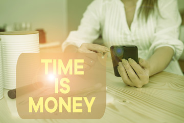 Writing note showing Time Is Money. Business concept for time is a valuable resource Do things as quickly as possible woman using smartphone and technological devices inside the home
