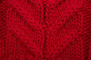 Knitted background red, close-up yarn structure