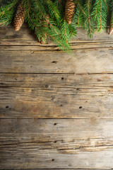 Christmas greeting background with Christmas tree branches, traditional decorations, gifts and xmas balls. Classic wooden background, top view flat lay copy space