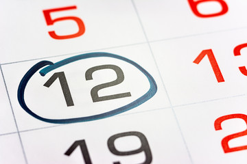 the twelfth day of the month highlighted on the calendar with a frame close-up macro, the mark on the calendar, the twelfth date