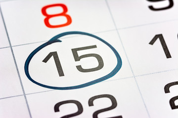 fifteenth of the month highlighted on the calendar with a frame close-up macro, mark on the...