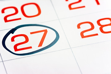 twenty-seventh of the month highlighted on the calendar with a frame close-up macro, mark on the...