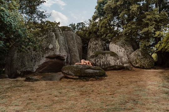 Nude woman lying on a rock at Beglik Tash prehistoric rock sanctuary, Bulgaria